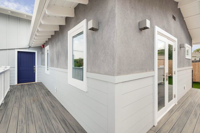 Composite deck and covered entry with blue front door