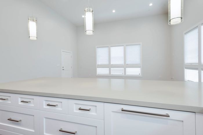 Quartz countertop run with pendant lighting above
