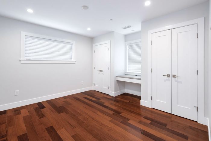 Bedroom with built-in desk nook and double closet doors