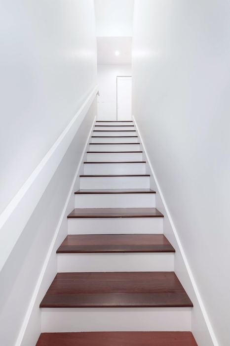 Staircase with solid hardwood treads and white painted risers